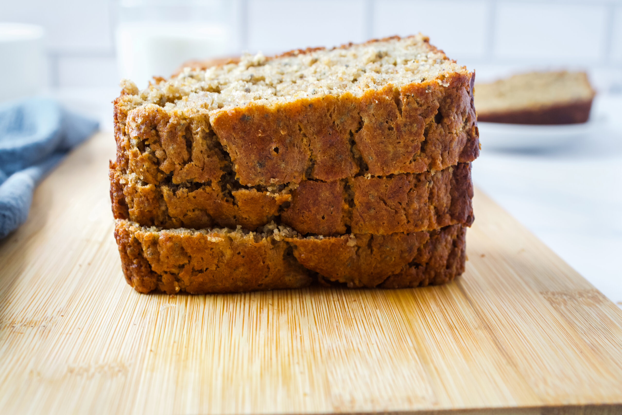 Stacked gluten-free banana bread on a wooden bord.