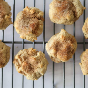 Tan cinnamon sugar cookies on a metal drying rack.
