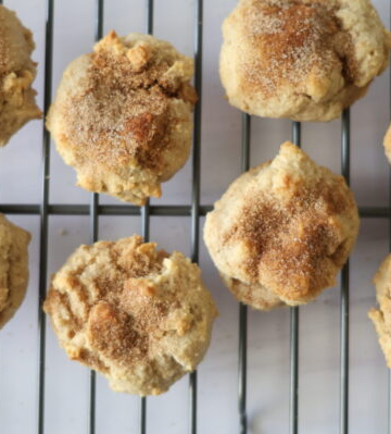 Tan cinnamon sugar cookies on a metal drying rack.