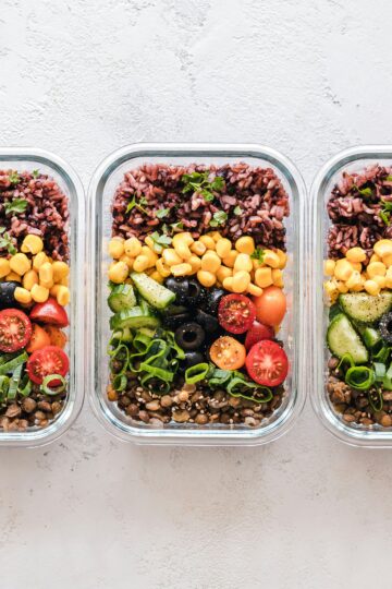 3 clear meal prep containers with vegetables and rice