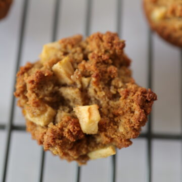 A gluten-free apple muffin on a wire drying rack