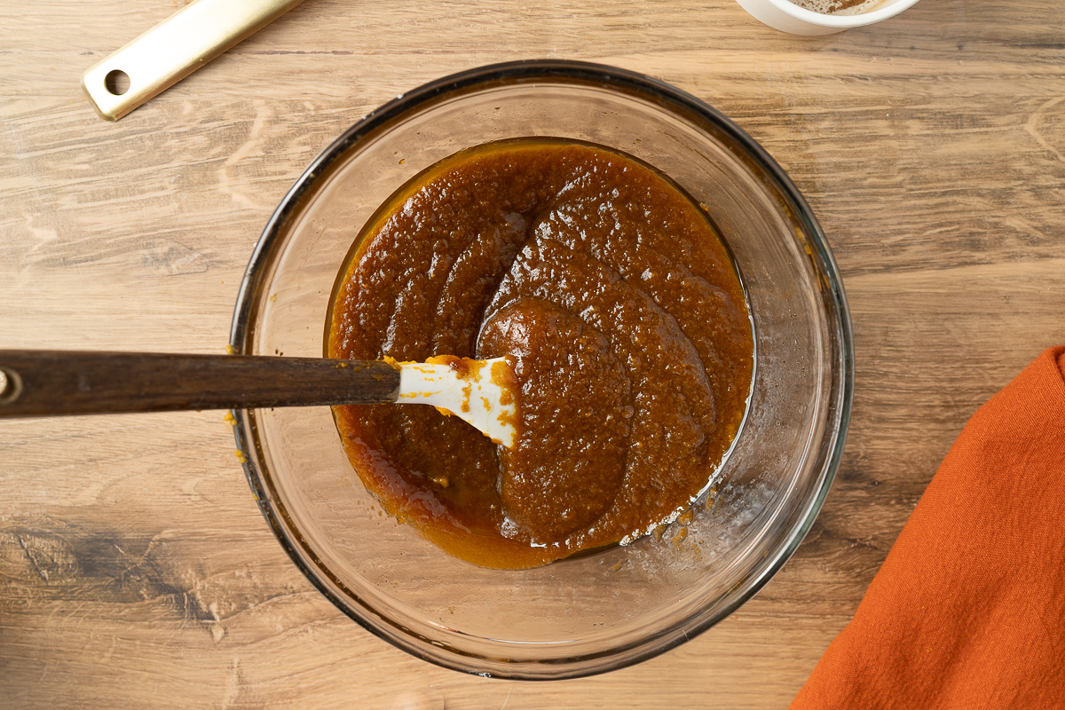 Pumpkin, sugar and vanilla in a clear mixing bowl.